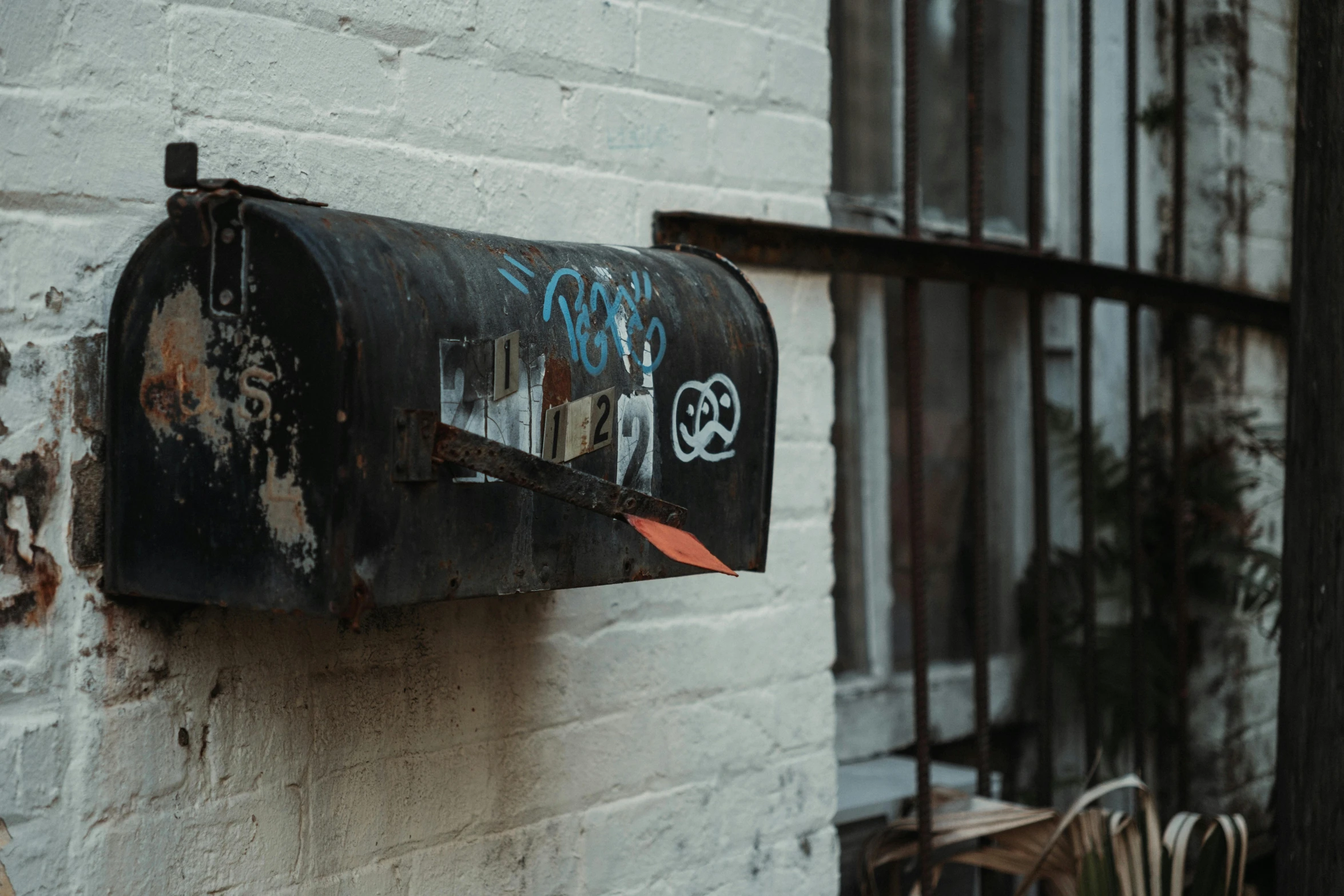 a close up of a mail box with grafitti on the outside