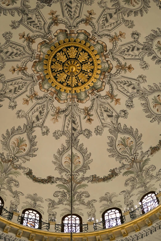 the ceiling in a building has large gold and black designs