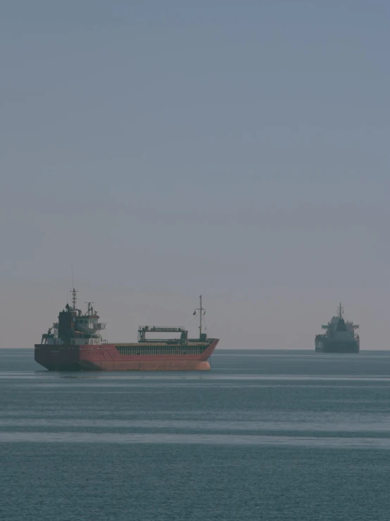 the boats are on the open water near the shore