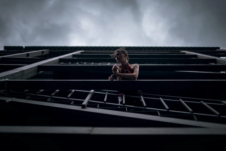 a girl is sitting in a building and looking out the window