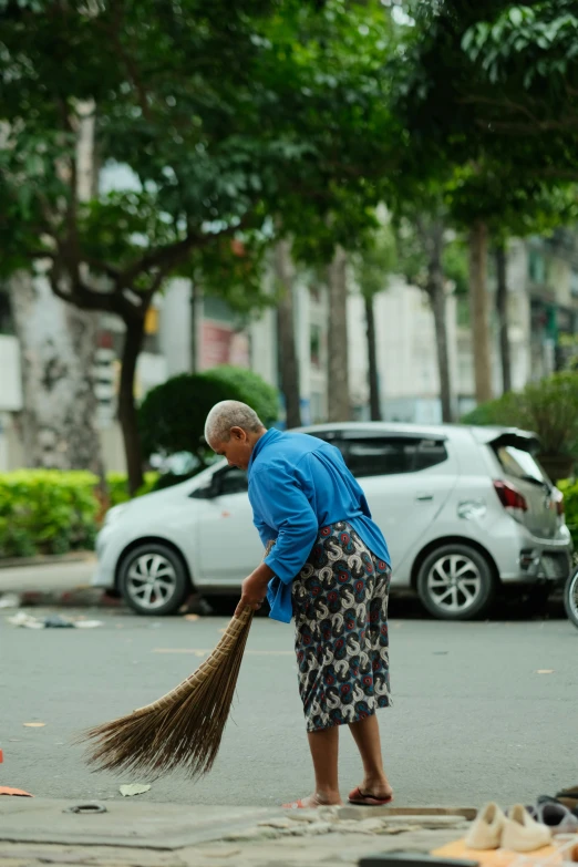 a man with a broom on the street