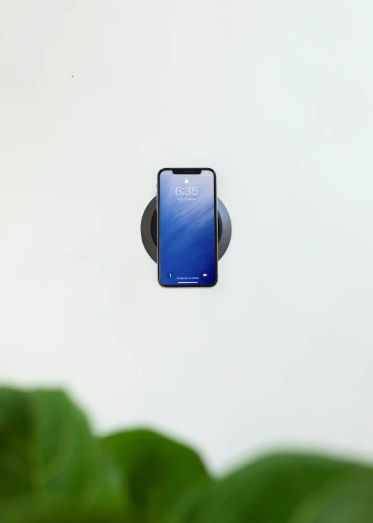 a cell phone on an angle mounted to a wall