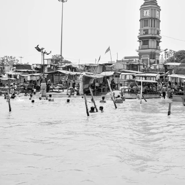 a tower building and several people standing on the pier