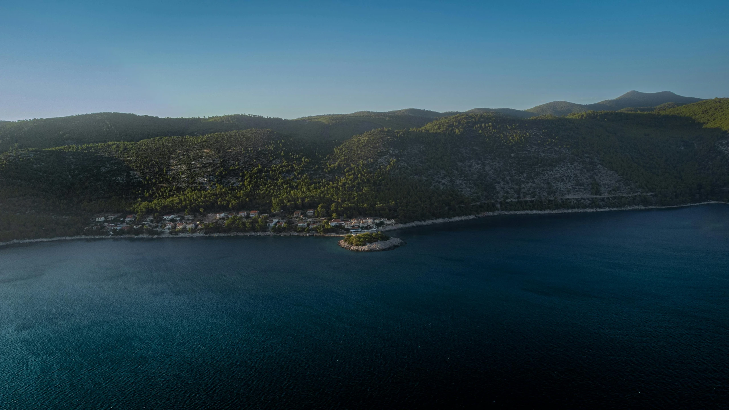 an aerial view of a mountain and lake