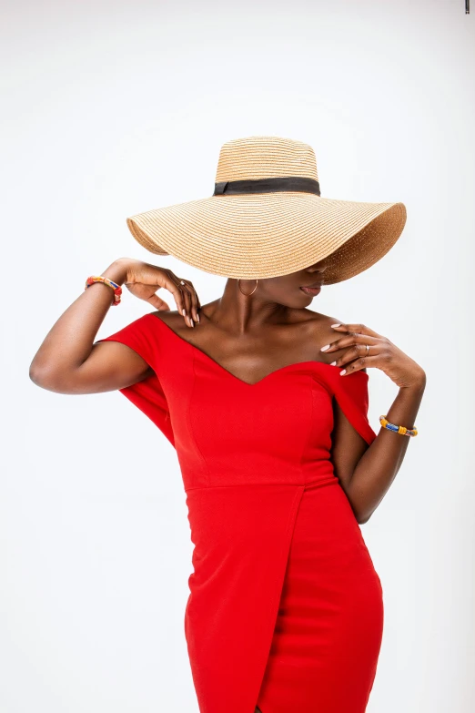 a woman in a red dress and straw hat