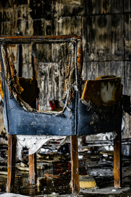 an old chair with peeling paint and broken pieces of fabric