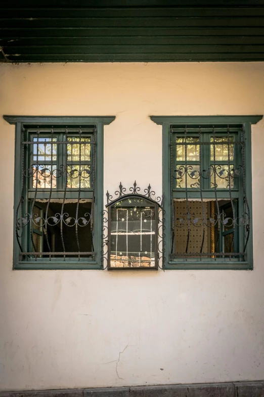 some green windows and some white walls