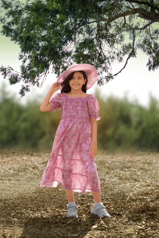 a  in pink is standing under a tree