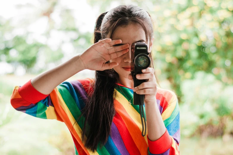 a woman holding up a camera to take a po