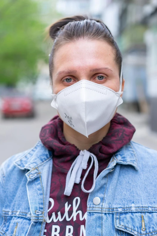 the woman wears a face mask to protect herself from pollution
