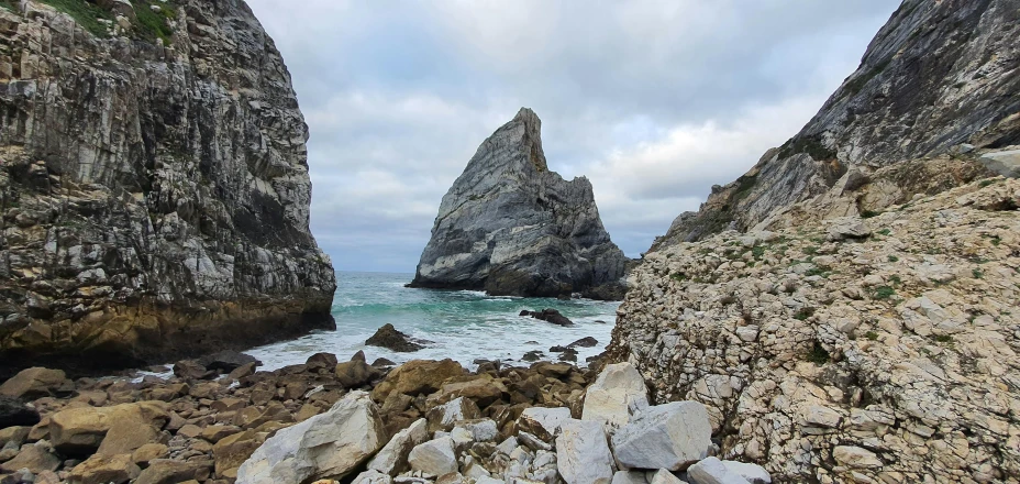 a rocky shoreline next to the ocean and an area with rock formations