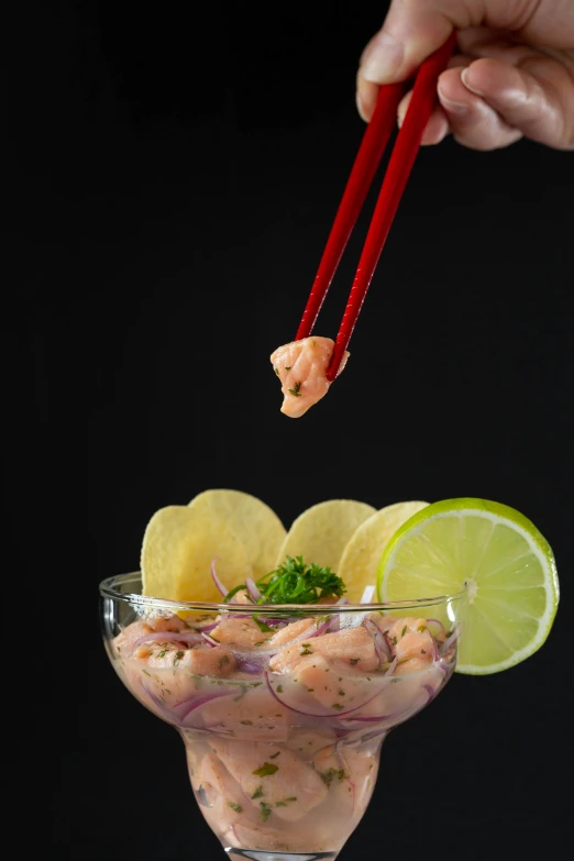 the shrimp is being scooped with chopsticks