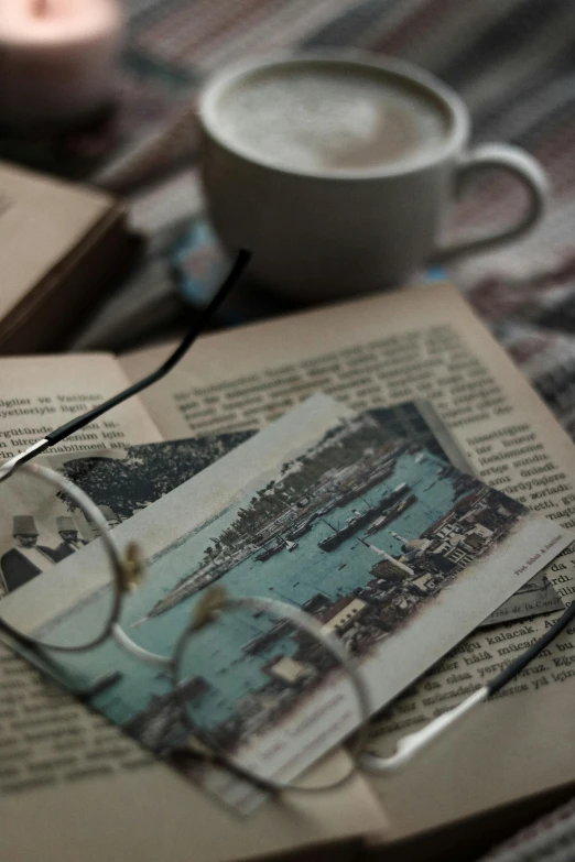 two books and glasses sit on a table