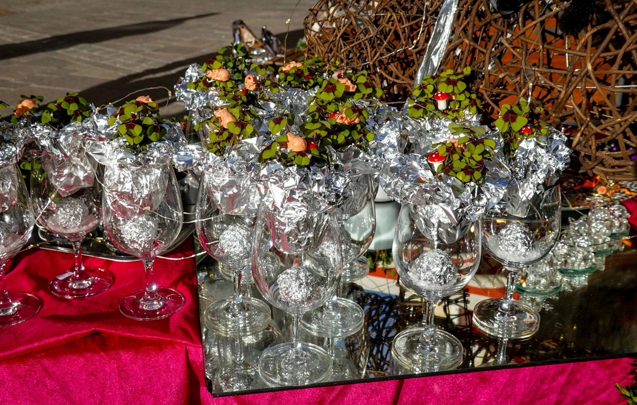 a lot of empty wine glasses next to some plants