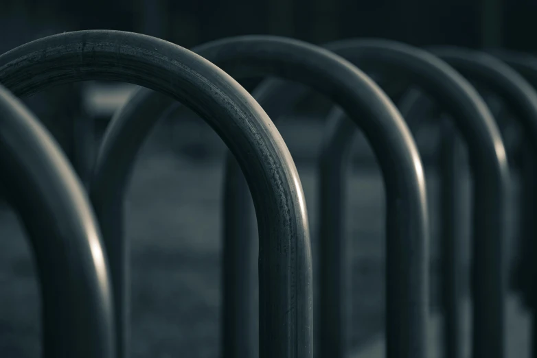 a row of metal seats sitting side by side on a sidewalk