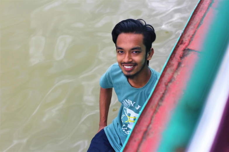 a man is leaning against the wall in water