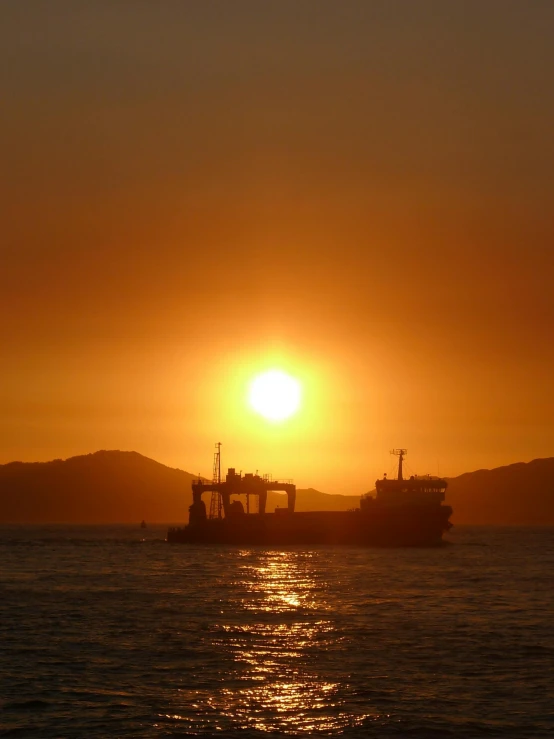 the sunset as seen from a ferry in the water