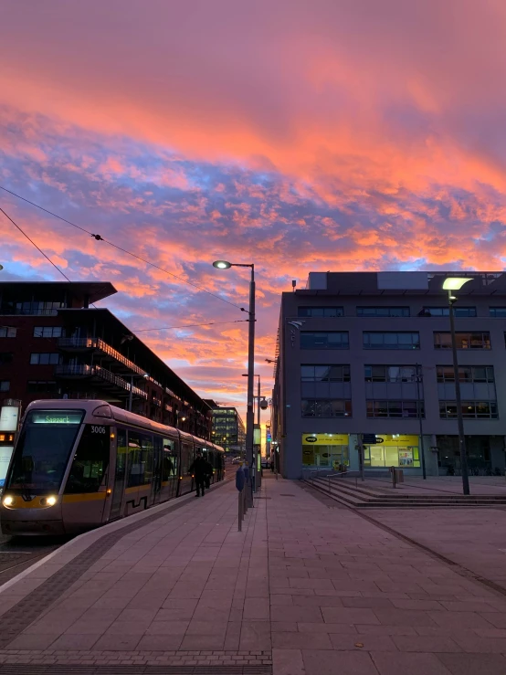 a city train on the tracks in front of buildings