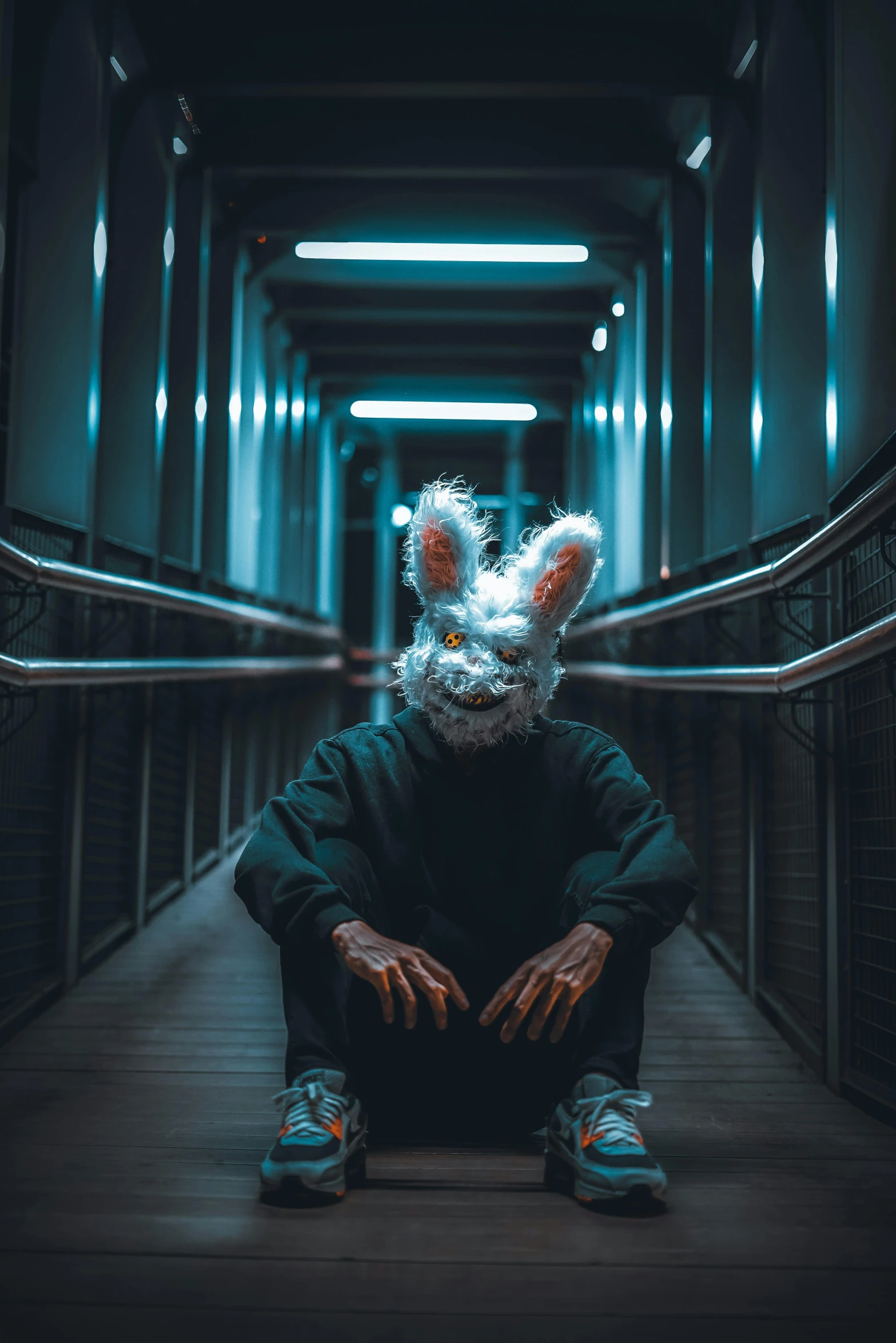 a man wearing a rabbit mask is sitting down