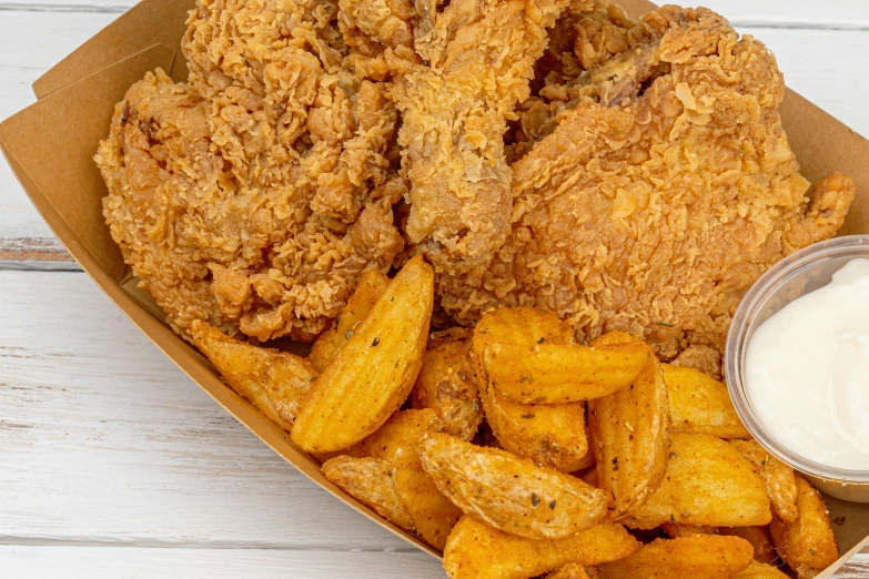 fried chicken and french fries are in a box