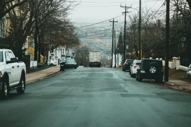 two trucks are driving down a road