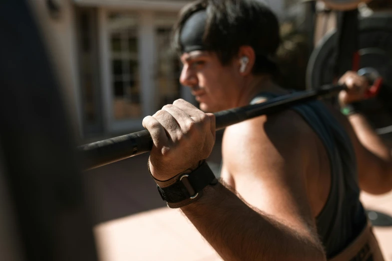 a man doing barbell dead swing with an extended handle