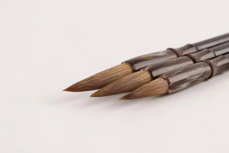 five wooden colored pencils lined up together