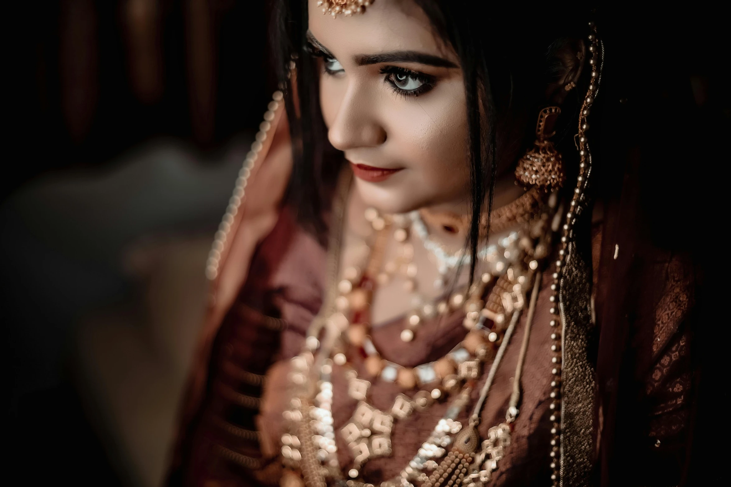 a woman is dressed in an elaborate indian wedding outfit