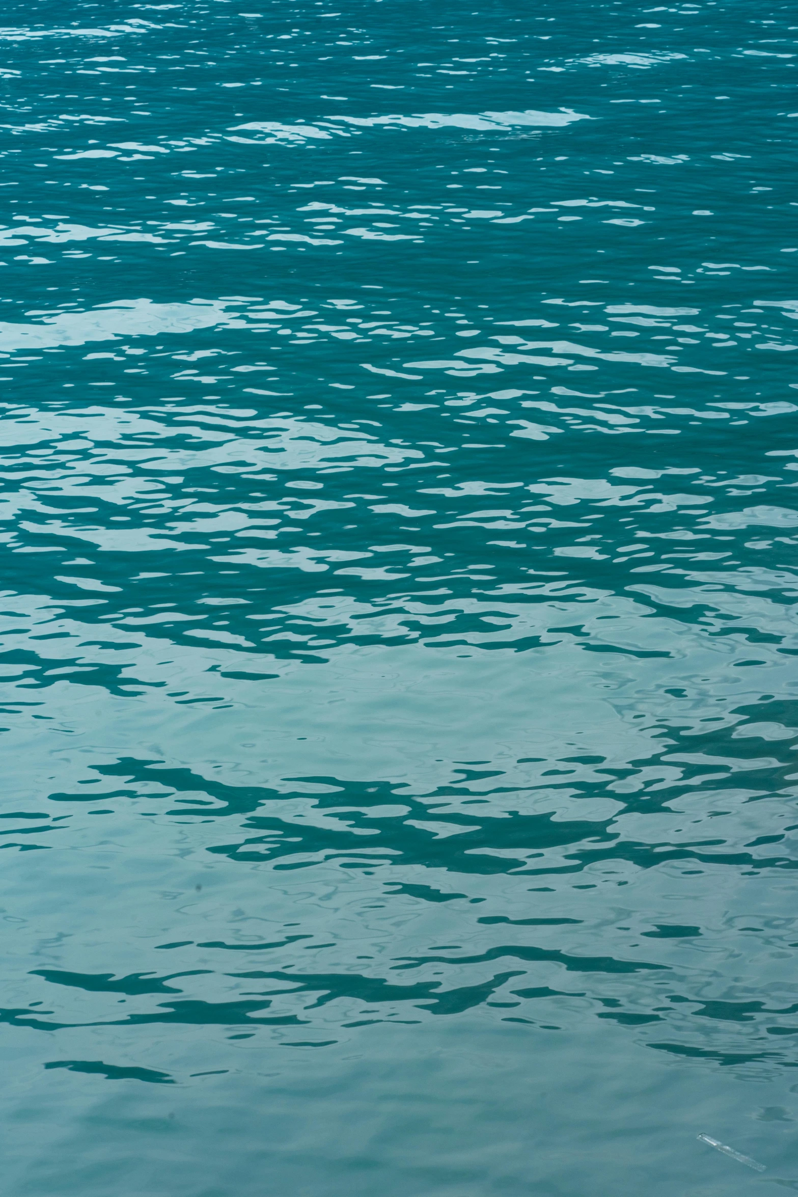 a single red boat in the water with green sea and sky background