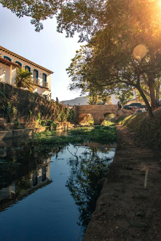 a house near a river, some water and trees