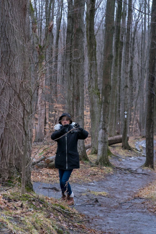 a woman wearing winter gear in the woods