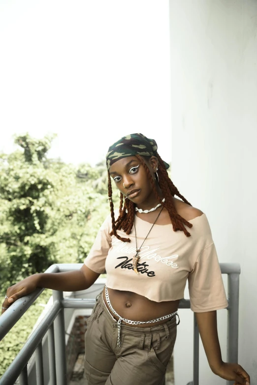 a young woman with dread locks wearing a top