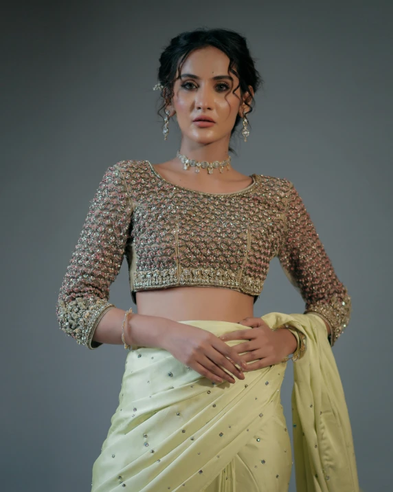 an indian woman with a large jewelled blouse and celets on