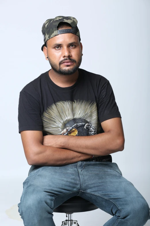 a man in a baseball cap sitting on a chair