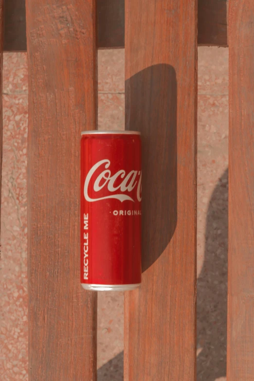 a close up of a can on a wooden wall