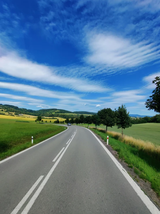 a long straight road in the middle of a country side