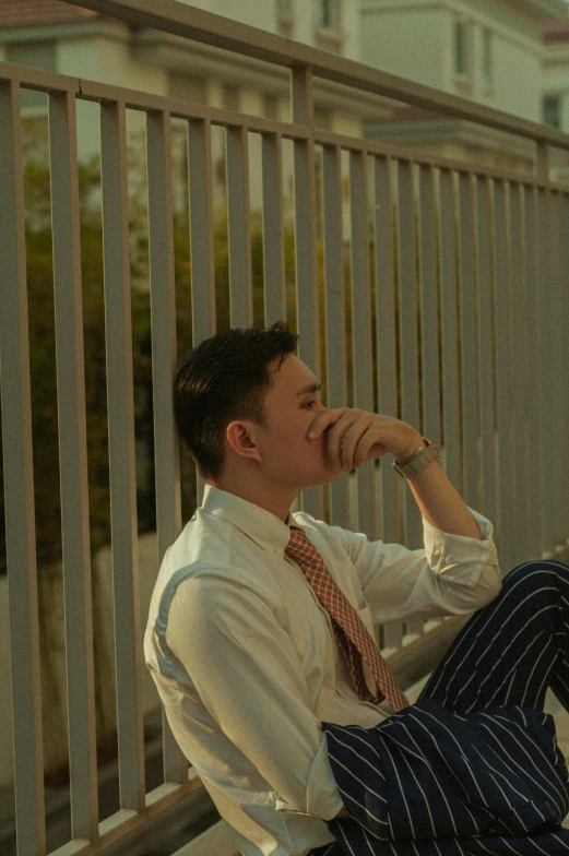 man in business attire sitting on a bench and posing