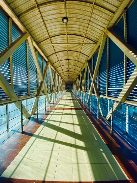 an empty covered walkway with blinds hanging from it