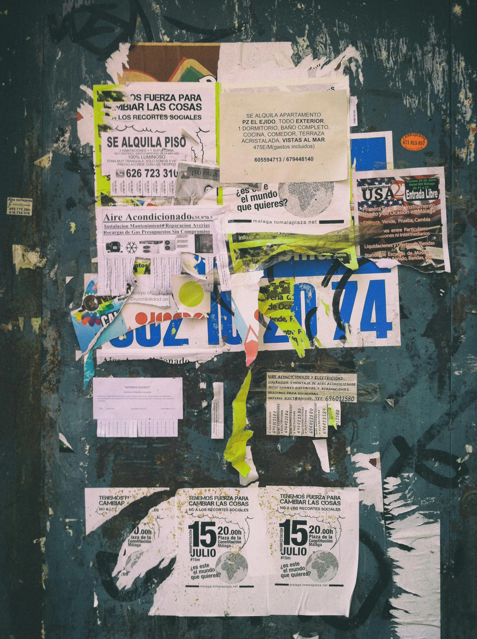 a bunch of paper advertises a sale on a wall