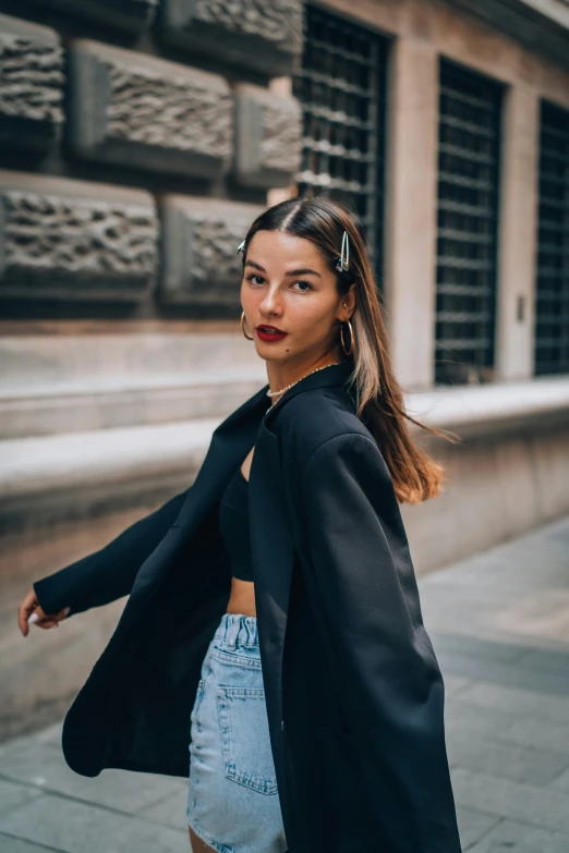 a  walking down the street with her hair in a ponytail