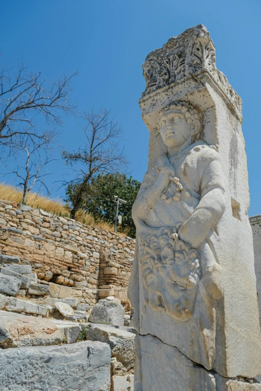 a very large and big statue by some rocks