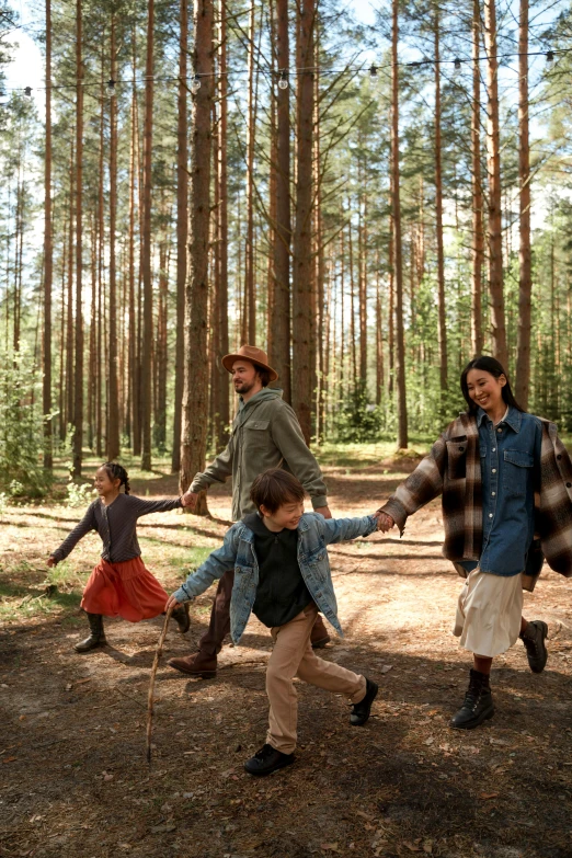 a group of young children playing in the woods