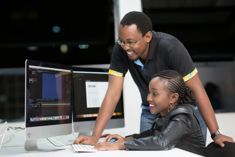 a man helping a woman get a computer