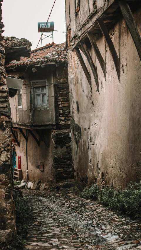 the corner of an alley way in old town with stone buildings