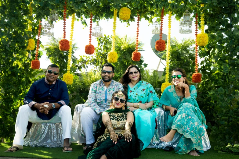 four people posing together in front of some decorations