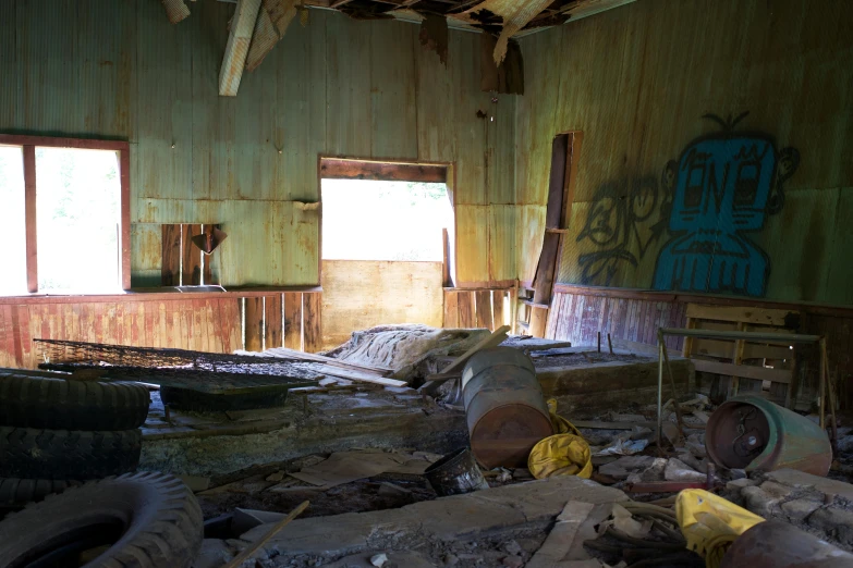 an abandoned house with graffiti painted on the walls and wood floors