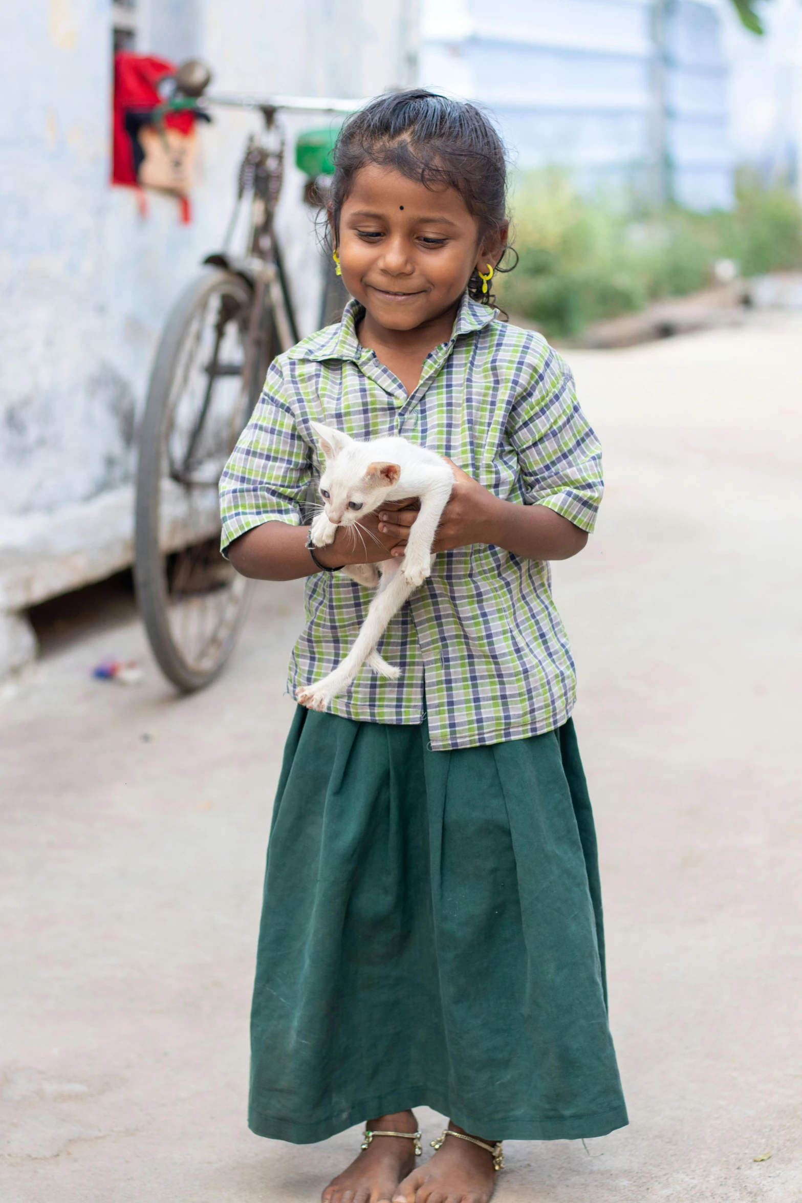 little girl holding a kitten in her hands