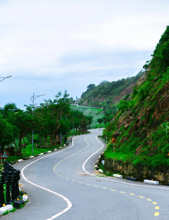 an empty street winding up into the mountains