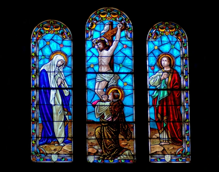 four stained glass windows depicting mary, jesus, and jesus in the sky