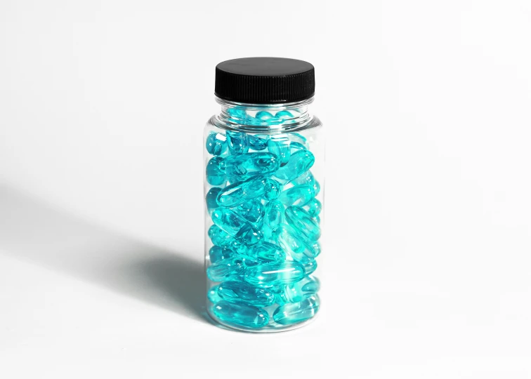 a glass jar with some blue beads in it